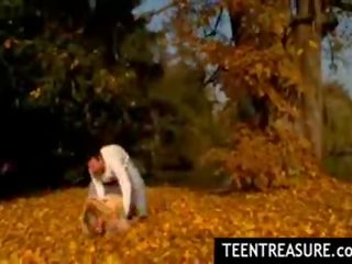 Chick couple kissing in park on nice autumn day